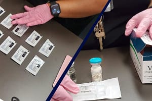 Doctor showing Suboxone and Vivitrol packaging